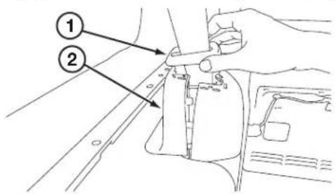 Technical diagram showing a hand operating a mechanical component with labeled parts 1 and 2