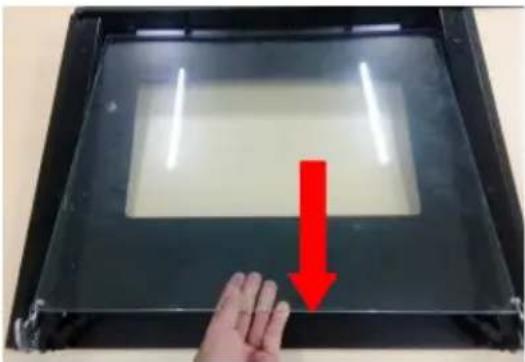 Hand pressing down on a transparent display panel with a red downward arrow indicating motion (no text or symbols visible)