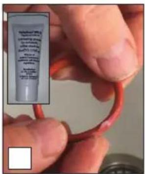 Close-up of hands holding a red tube with visible text, likely a product or sample labeled 'Papilled Capsules'