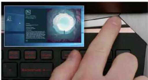 Hand interacting with a laptop displaying a file browser interface and a preview window showing a glowing tunnel or light source.