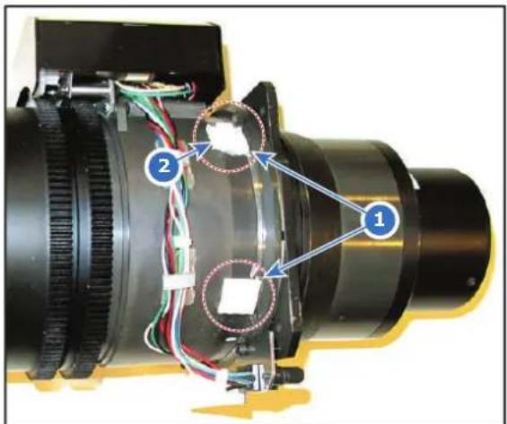 Labeled diagram of a mechanical device showing components with numbered annotations (1, 2) and wiring connections.
