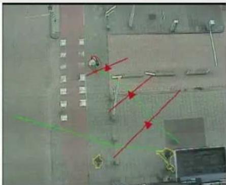 Aerial photo of an industrial facility with visible red arrows indicating motion or signal paths, and a circular marker on the left.