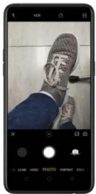 Smartphone screenshot showing a photo of a shoe with visible text overlays and UI controls