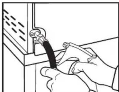 Illustration of hands using a tool to connect a component into a cabinet (no text or symbols visible)