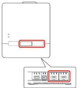 Diagram showing a device with a red rectangular button and a zoomed-in view of internal components, likely illustrating a system or device layout.