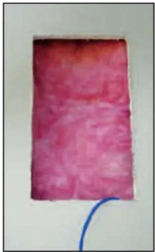 Solid pink textured rectangular object with a blue curved line at the bottom right (no text or symbols)