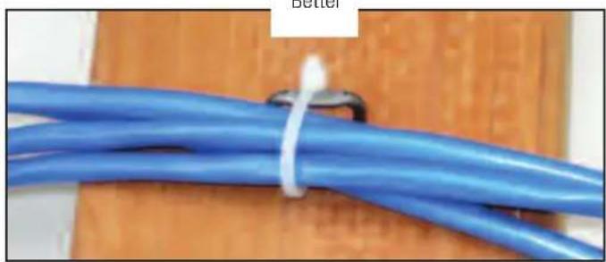 Close-up of a blue cable with white tape tied on a wooden surface (no text or symbols visible)