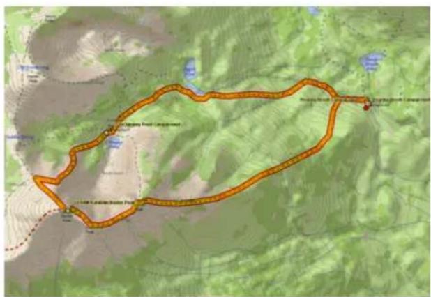 Map showing a route through a mountainous area with labeled locations and a red arrow indicating the path.