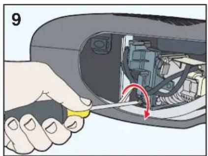 Hand holding a yellow tool inside a car engine compartment, with a red arrow indicating the tool's direction (no text or symbols present)
