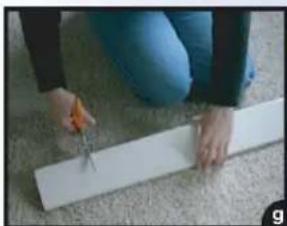 Person using a tool to cut or trim a white strip on a carpet (no text or symbols visible)