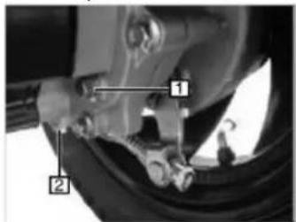 Technical diagram showing mechanical components with numbered labels 1 and 2 pointing to specific parts of a vehicle wheel or tire assembly.