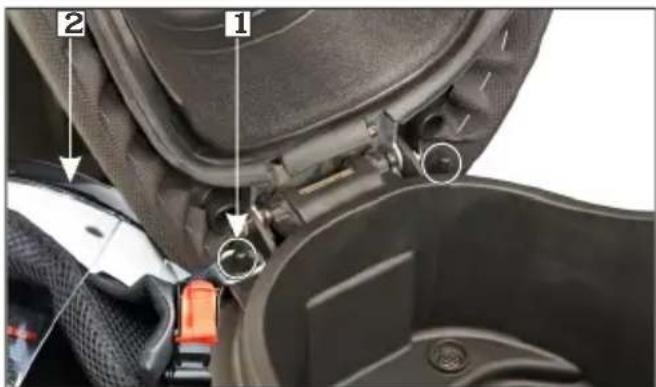 Close-up of car seat assembly with numbered labels pointing to mechanical components