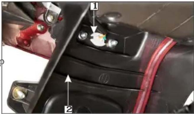 Close-up of a car's battery terminal with labeled parts and arrows indicating components
