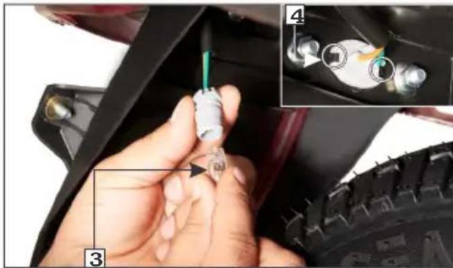 Close-up of a hand holding a small electrical connector with visible wiring, alongside an inset showing close-up details of a component with colored wires.