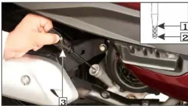 Close-up of a car engine component with labeled parts and an inset diagram showing parts numbered 1 and 2.