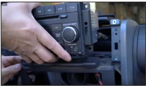 Close-up of a hand interacting with a camera module, showing control panel and status indicators in Chinese