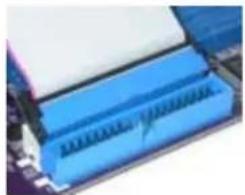 Close-up of a blue electronic component with a white top, possibly a memory or connector (no visible text or symbols)