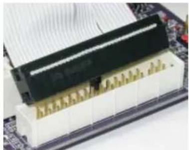 Close-up of a computer RAM module with gold contacts and a black memory card on top (no visible text or symbols)