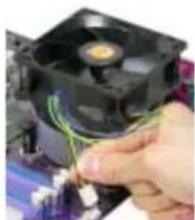 Close-up of a hand holding a CPU socket with visible wiring, no text or symbols present