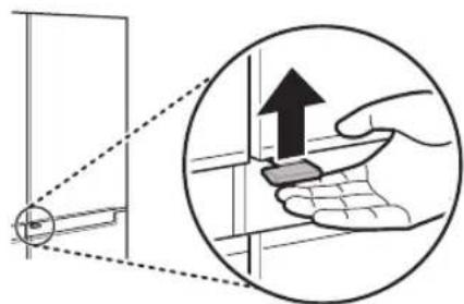 Diagram illustrating a hand using a tool to interact with a wall-mounted device, showing an upward arrow and magnified detail.