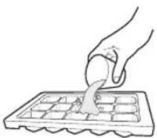 Hand using a tool to cut or spread a grid on a griddle (no text or symbols visible)