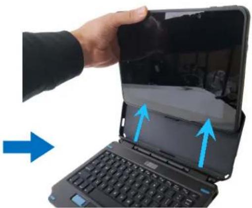 Hand holding a tablet device with blue arrows pointing to the screen area, next to a laptop keyboard (no text or symbols visible)