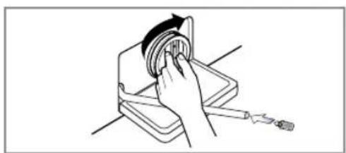 Line drawing of a hand using a tool to lift a circular component (no text or symbols)