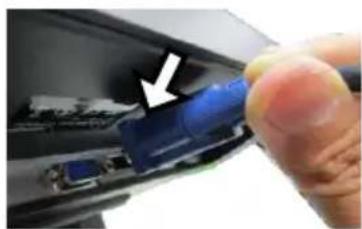 Close-up of a finger pressing a blue USB flash drive into a black electronic device (no text or symbols visible)