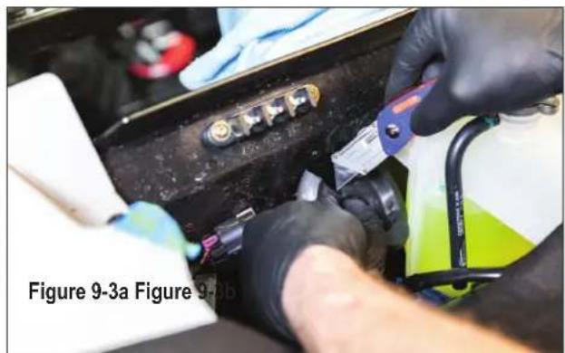 Close-up of hands installing or adjusting a mechanical component with a blue tool (no visible text or symbols)
