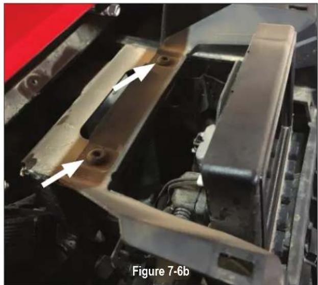 Close-up of a mechanical component with white arrows pointing to features, labeled as Figure 7-6b (no readable text or symbols beyond label)