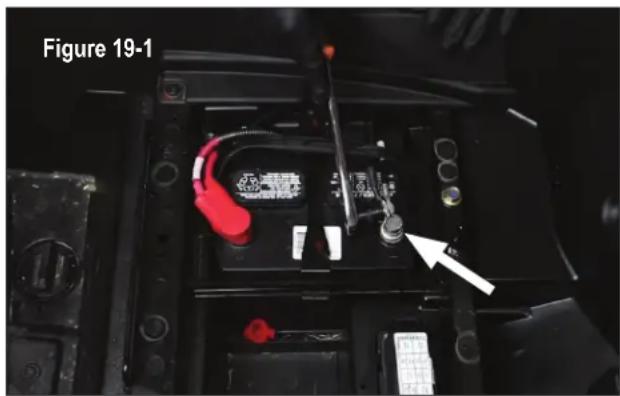 Interior view of a battery pack with visible wiring and a white arrow pointing to a component (no text or symbols)