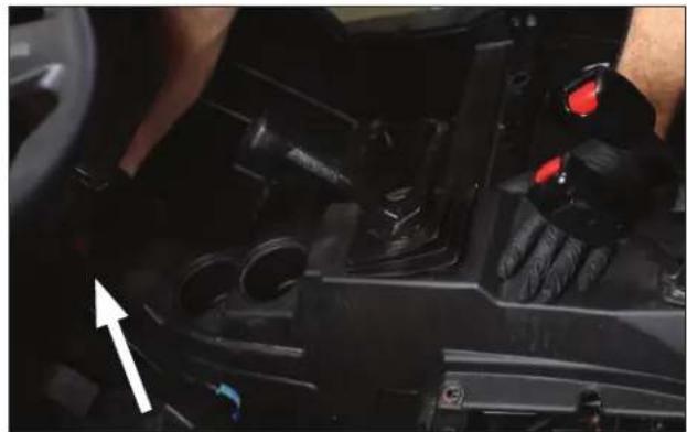Close-up of a car interior showing hand positioning and control panel (no visible text or symbols)