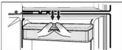 Diagram of a mechanical press or clamping device with hands operating a component (no text or symbols visible)