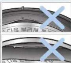 Cropped image showing two cropped text fragments with blue 'X' marks, likely from a document or interface.