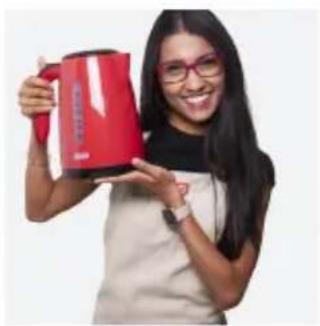 Woman smiling while holding a red coffee mug (no visible text or symbols)