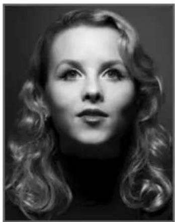 Black-and-white portrait of a woman with styled wavy hair and turtleneck (no text or symbols visible)