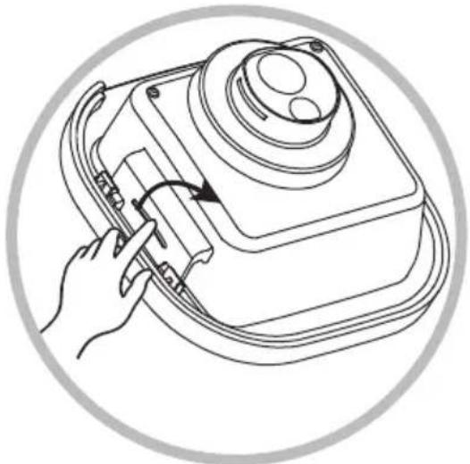 Line drawing of a hand using a tool to adjust or install a device inside a circular frame (no text or symbols)
