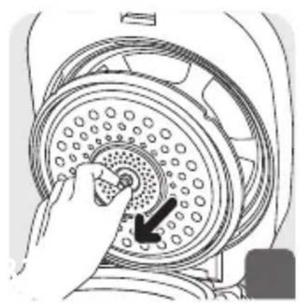 Hand pressing a button on a circular mechanical component with holes (no text or symbols visible)