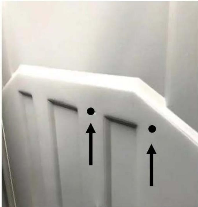 White wall-mounted panel with two black arrows pointing upward, no text or symbols present