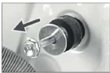 Close-up of a mechanical component with a metallic fitting and a black arrow pointing to it (no visible text or symbols)