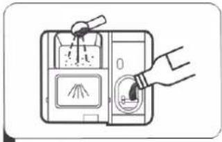 Diagram showing a hand inserting a bag into a device with labeled parts and a cloth inside, likely illustrating a cleaning or cleaning process.