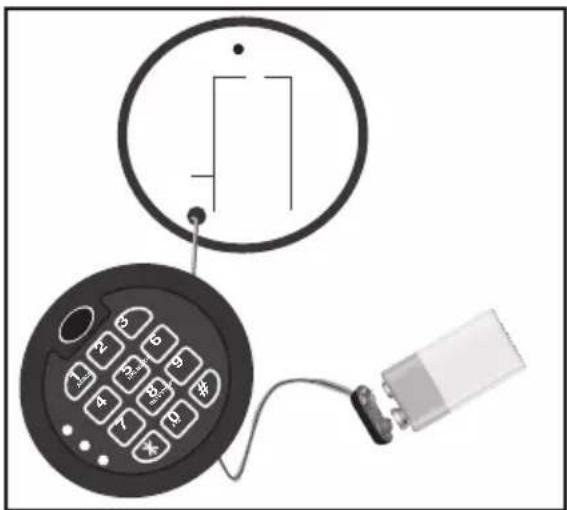 Diagram showing a circular device with a rectangular symbol and a keypad connected to a battery, illustrating a basic electrical or electronic circuit setup.