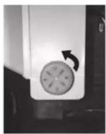 Close-up of a circular mechanical component with an arrow indicating rotation (no visible text or symbols)
