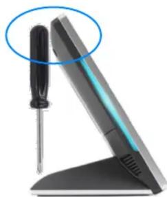 Close-up of a screwdriver on a flat-screen computer monitor stand (no text or symbols visible)