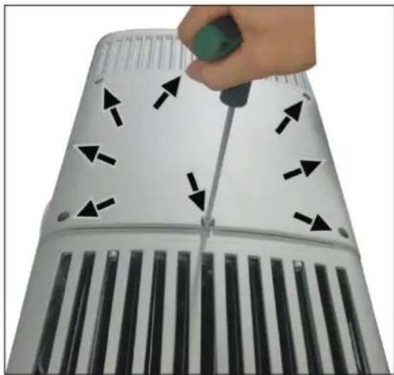 Close-up of a hand using a screwdriver to adjust black arrows on a white cylindrical device with ventilation grilles (no text or symbols visible)