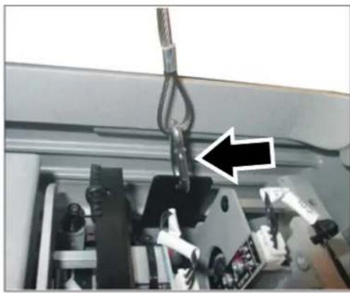 Close-up of mechanical components with a hanging hook and a black arrow pointing to a component (no visible text or symbols)
