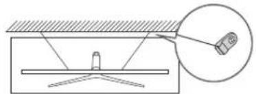 Diagram showing a mechanical setup with a lever and a magnified inset of a device (no text or symbols)