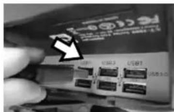 Close-up of a hand holding a network device with labeled ports and an arrow pointing to a specific port.