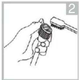 Line drawing of a hand holding a tool with a brush (no text or symbols)