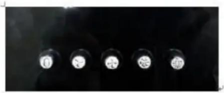 Five circular light sources on dark background, no visible text or symbols